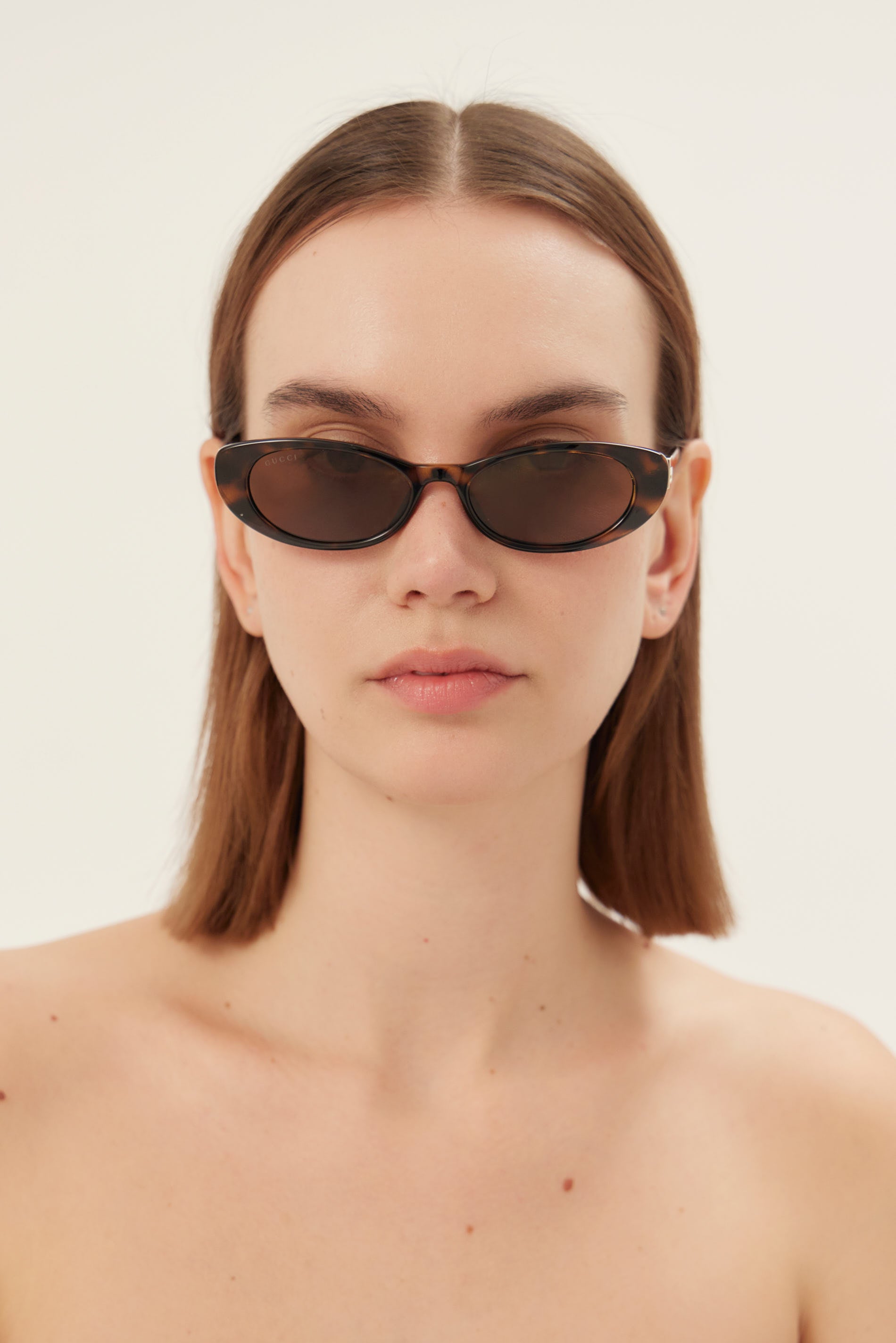 Oval cat-eye havana brown Gucci sunglasses with gold logo