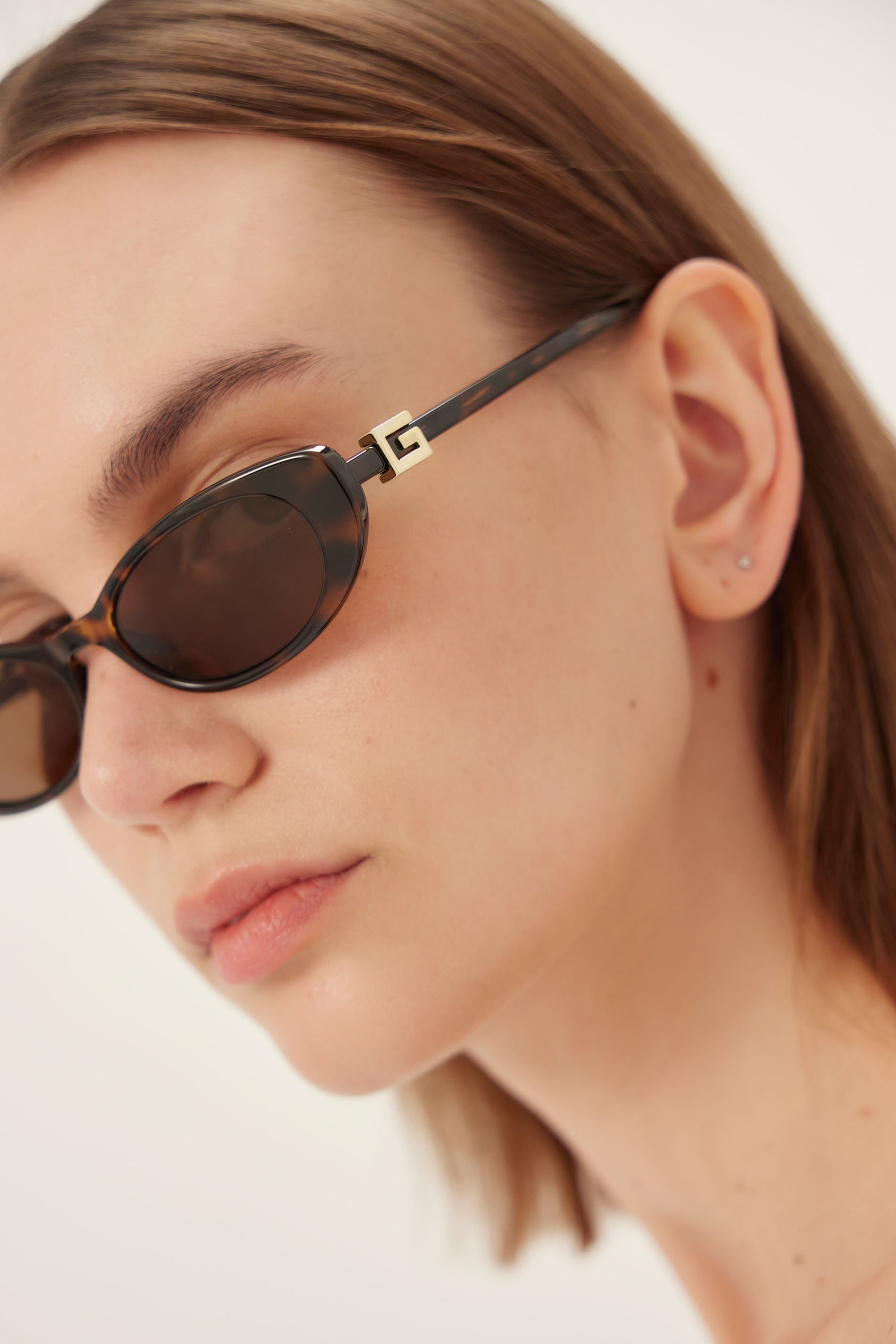 Oval cat-eye havana brown Gucci sunglasses with gold logo